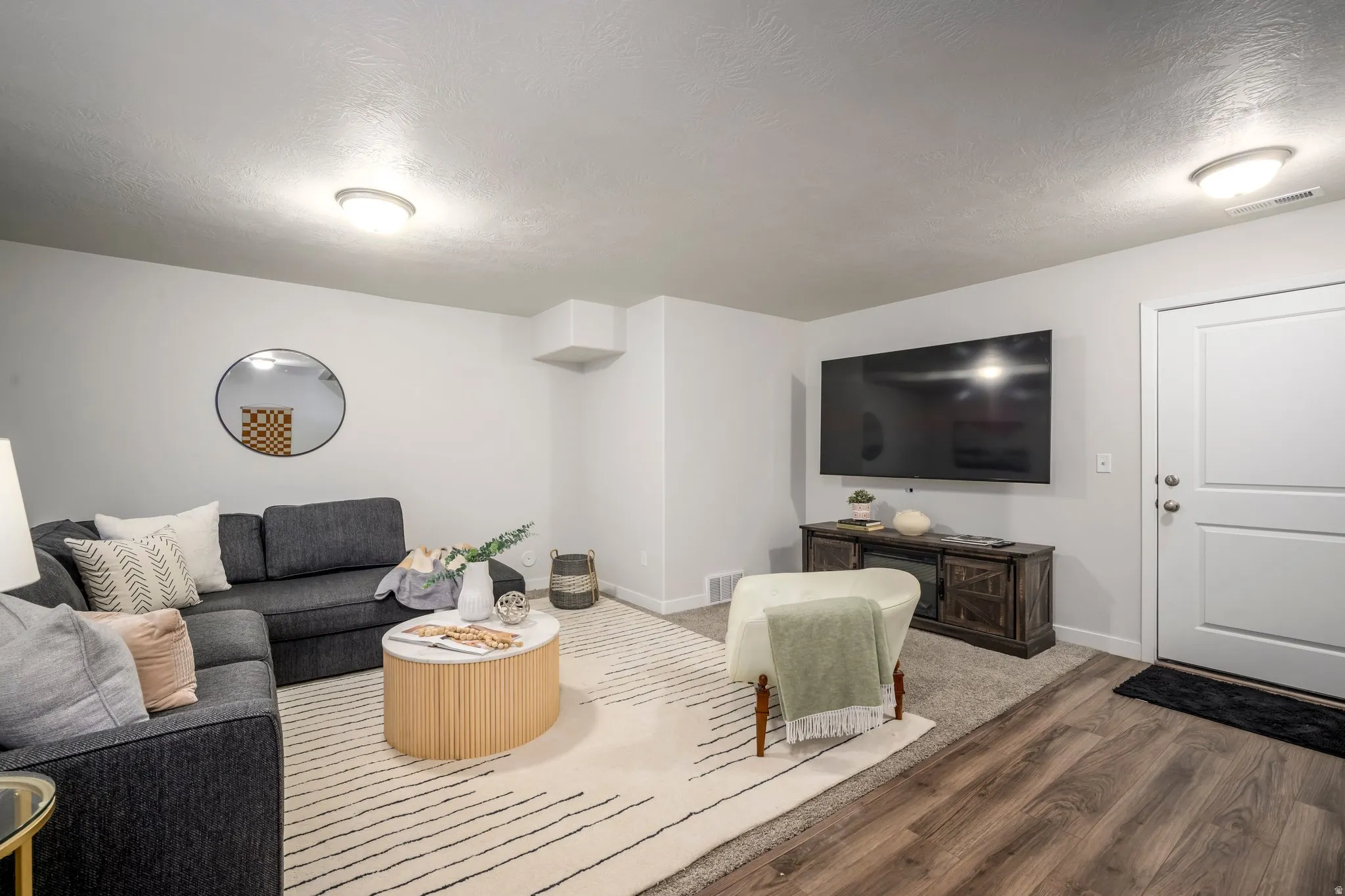 Recessed lighting, wood-finish flooring, and light wall tones