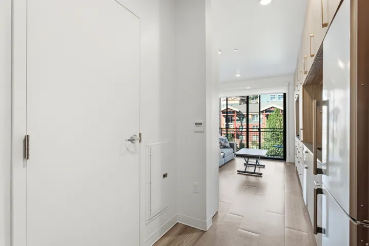 Recessed lighting illuminates the wood-finish flooring