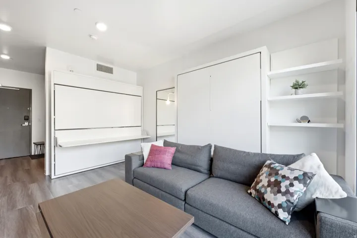 Wood-finish flooring, white walls, and recessed lighting
