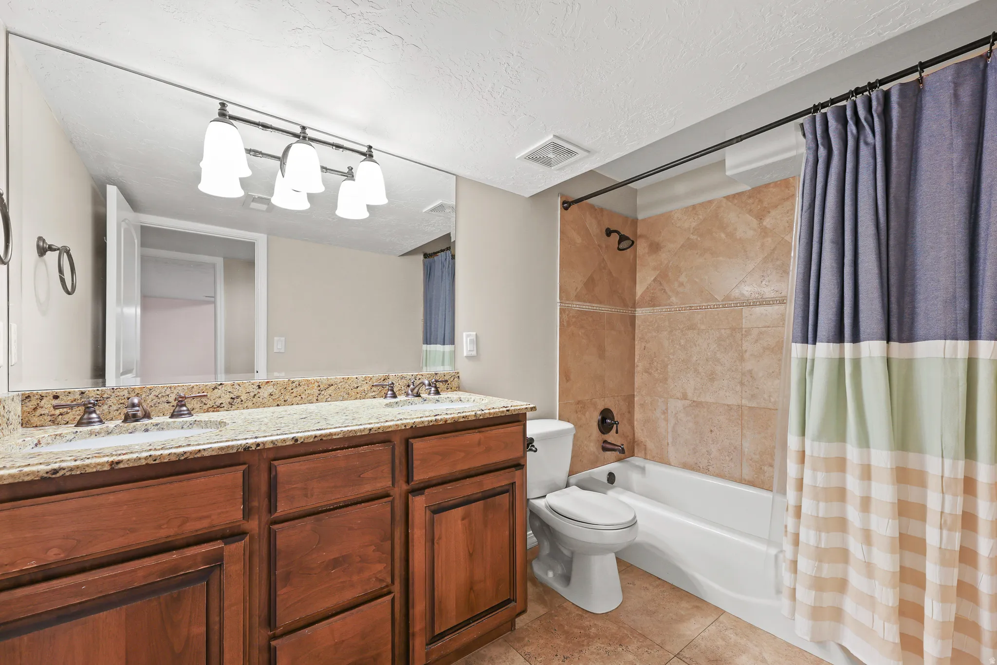 Double vanity with integrated sinks and granite countertop