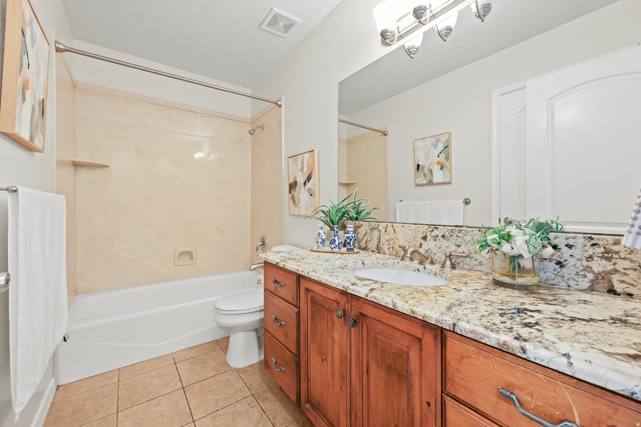Wood-finish vanity with an integrated sink and stone countertop