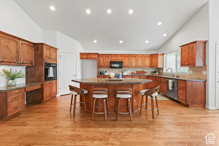 Vaulted ceilings, recessed lighting, wood-finish flooring, wood cabinetry, and an integrated oven