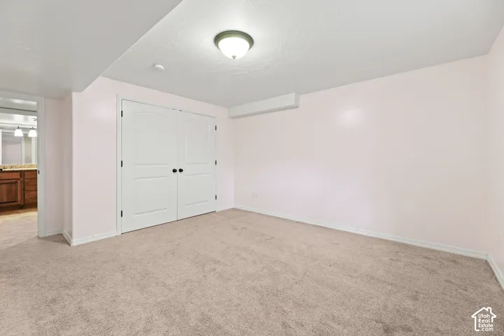 Neutral-toned carpeting paired with light pink walls