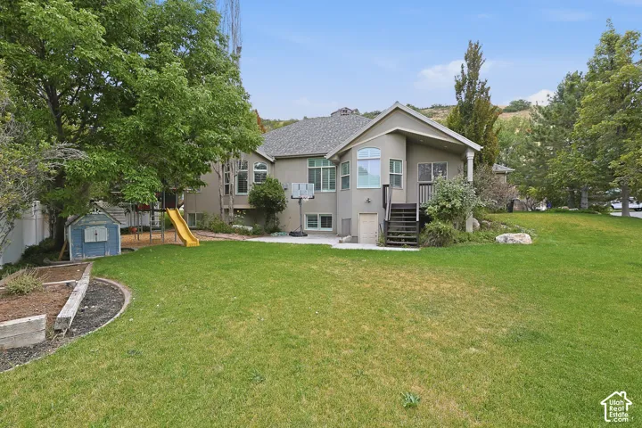 Expansive lawn with mature trees and raised garden beds
