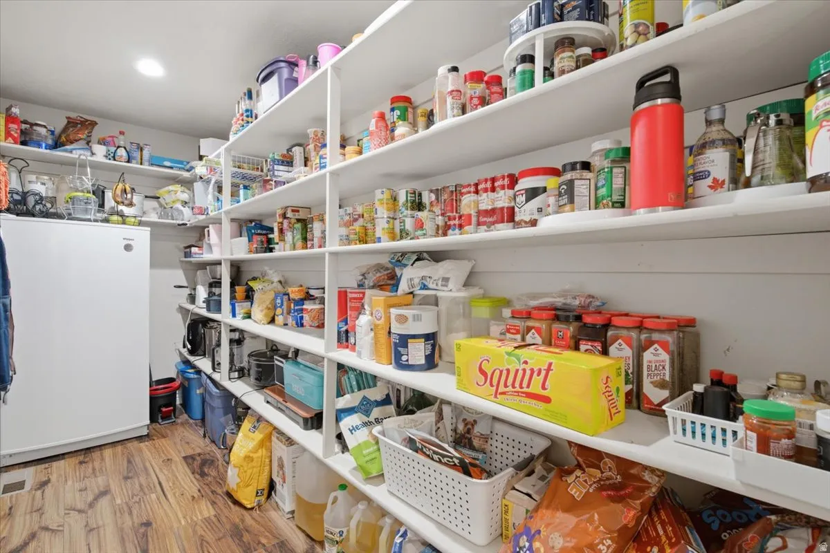 Integrated pantry shelving with wood-finish flooring