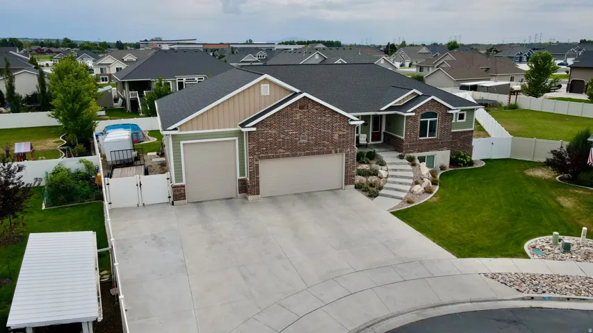 Brick and siding exterior featuring a two-car garage