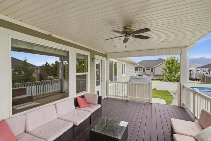 Covered porch featuring a ceiling fan, recessed lighting, and dark wood-finish decking