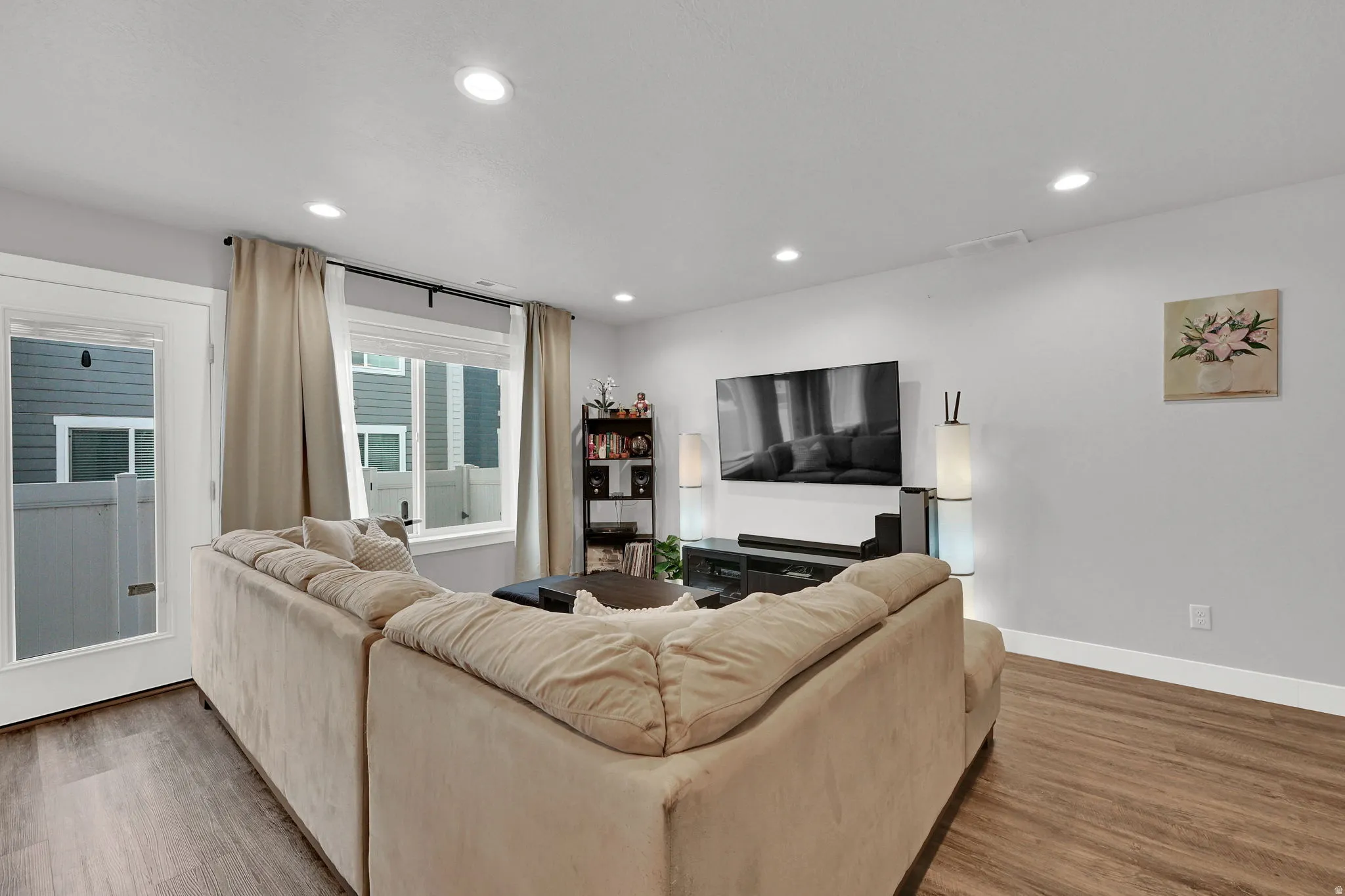 Recessed ceiling lighting, durable LVP flooring, white walls