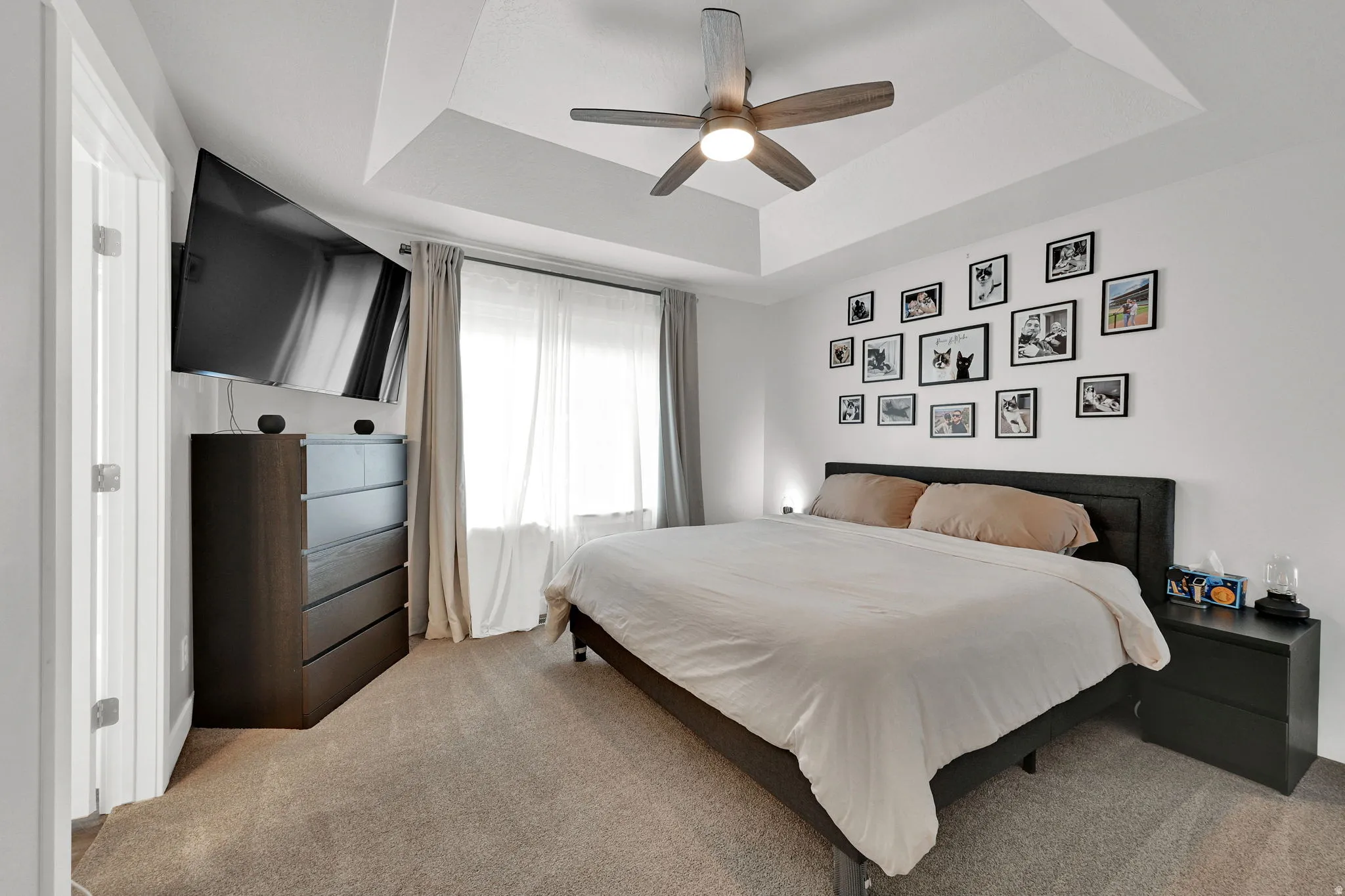 Master bedroom featuring a coffered ceiling  and fan