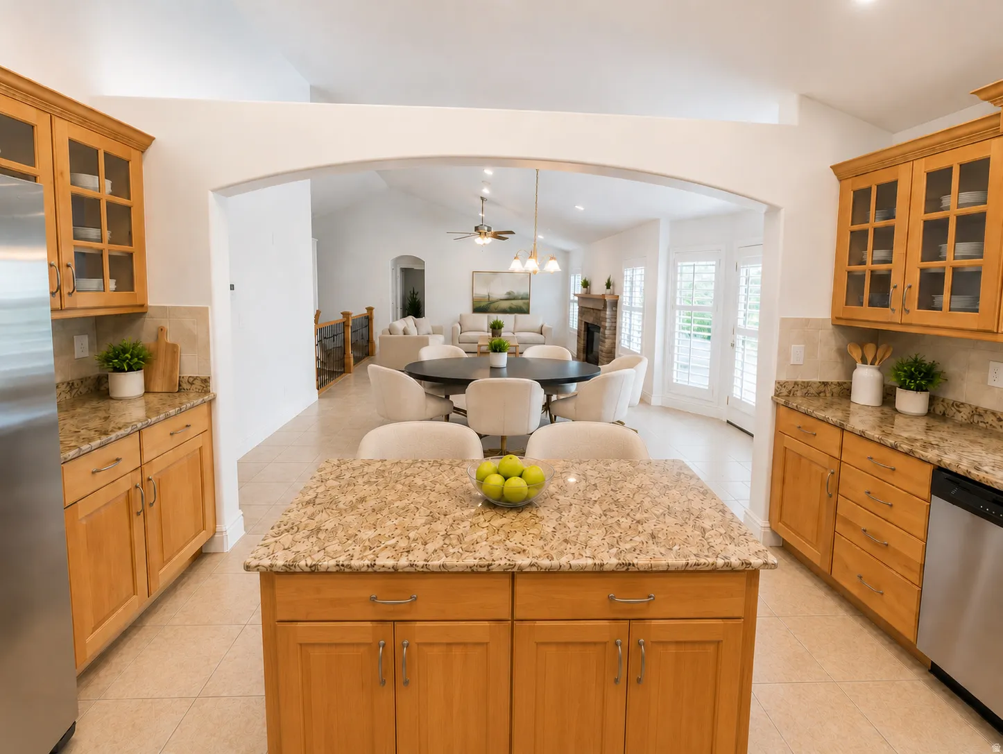 Kitchen featuring light wood cabinetry, granite countertops, tile flooring, and stainless steel appliances