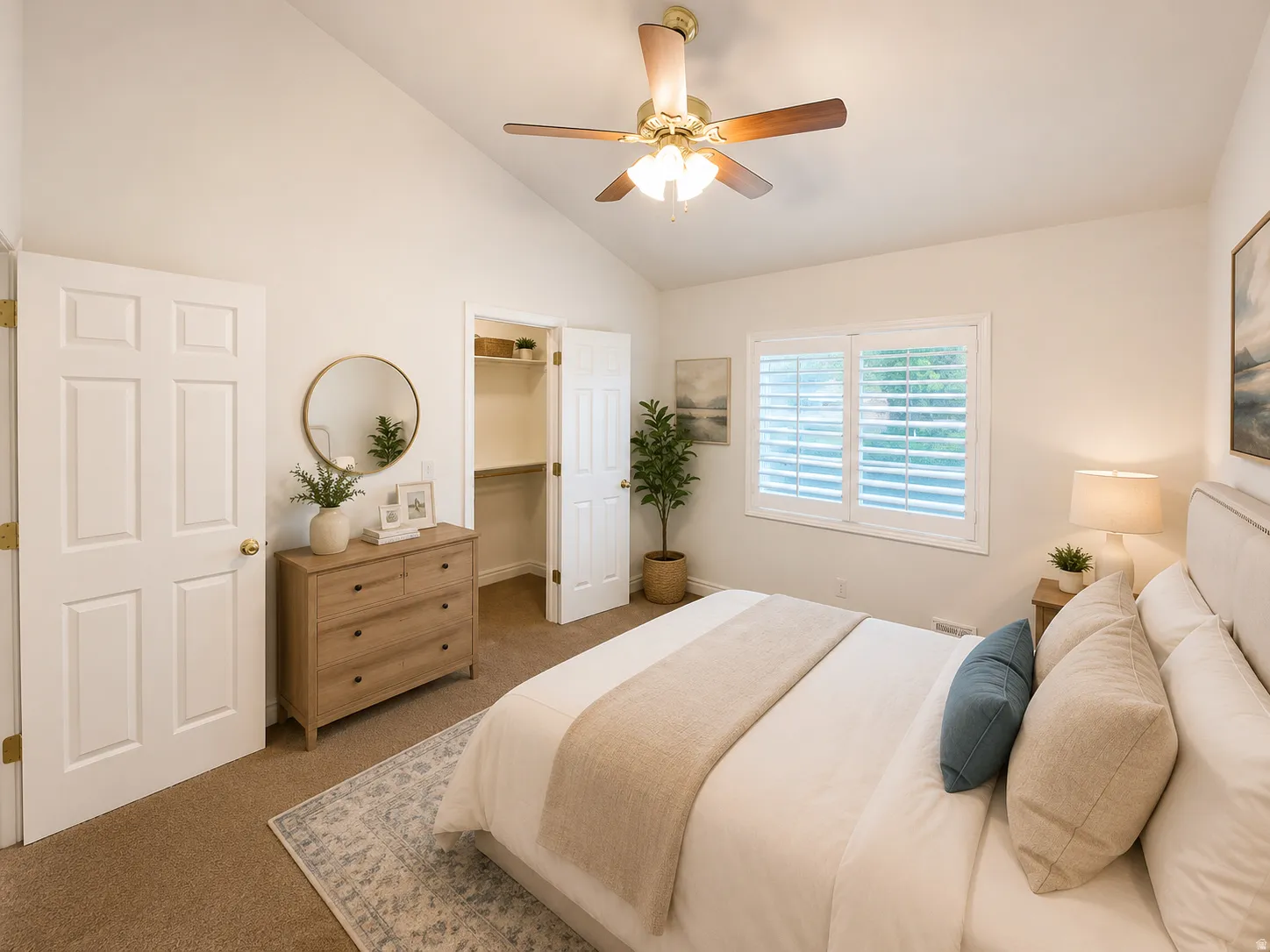 Vaulted ceiling with a ceiling fan, white paneled doors, recessed closet, and a double window with plantation shutters