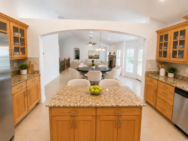 Kitchen featuring light wood cabinetry, granite countertops, tile flooring, and stainless steel appliances