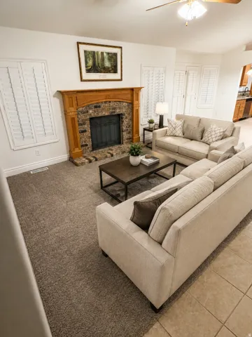 Wood-finish mantel with brick-surround fireplace