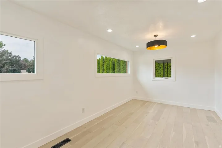 Light wood-finish flooring with white walls