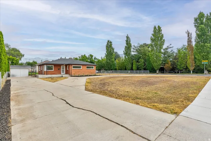 Spacious concrete driveway and parking area with ample room for multiple vehicles
