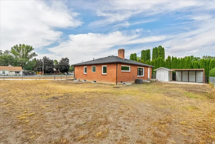 Brick residence with a spacious front-facing lot, and detached outbuildings