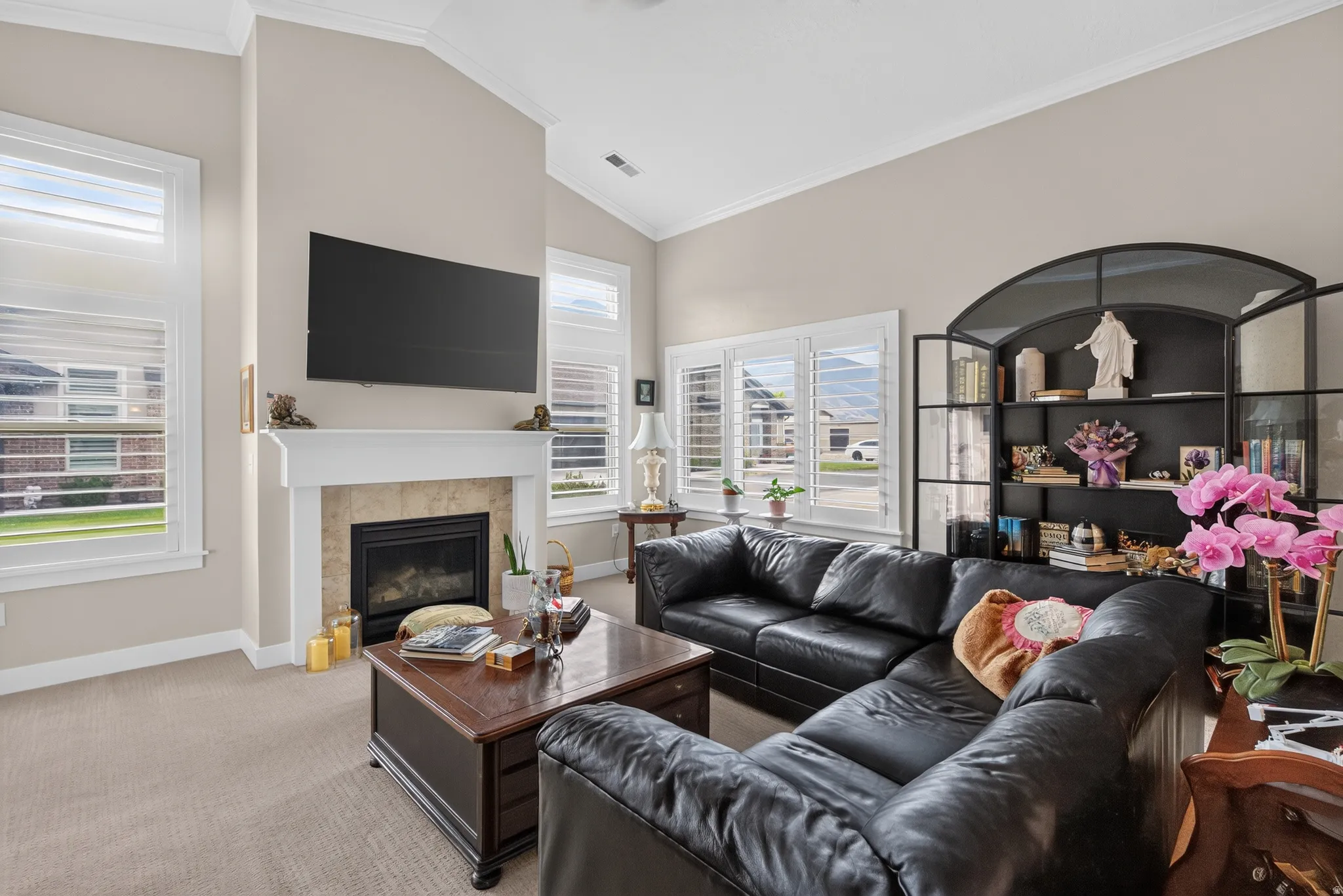 Sophisticated living room anchored by a gas fireplace with a linear design and built-in shelving