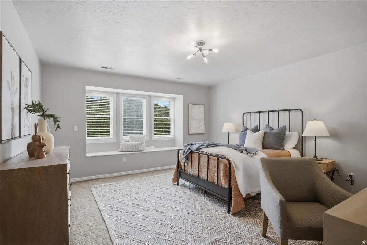 Recessed window seat with three windows, modern ceiling light fixture, and light gray wall paint