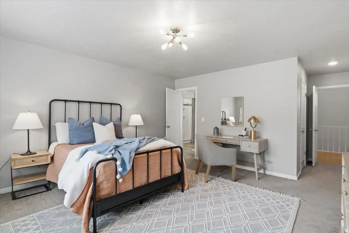 Recessed lighting, ceiling-mounted light fixture, carpeted flooring, and a white interior door