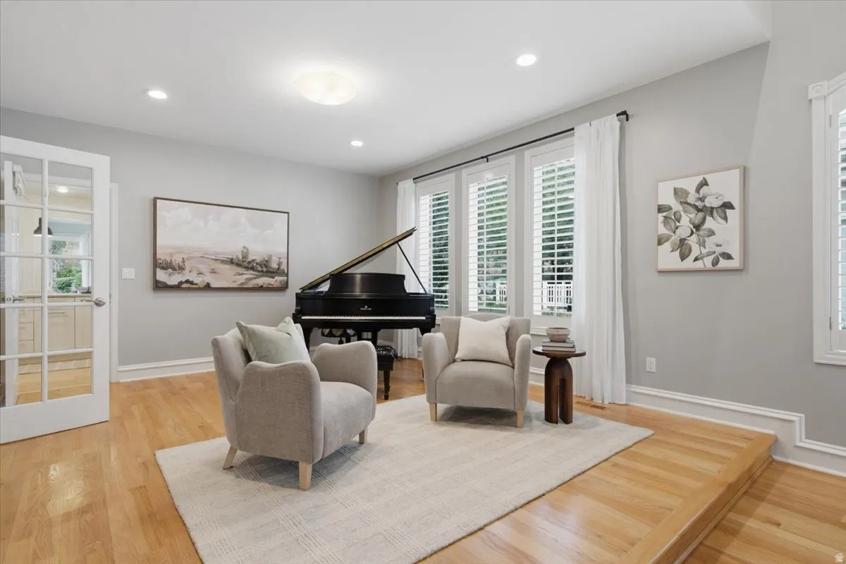 Hardwood flooring, recessed lighting, and a stepped-down area