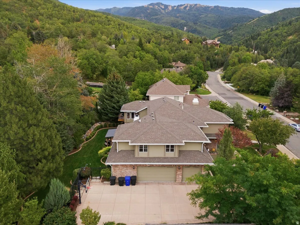 Property featuring a multi-level design, attached garage, and a concrete driveway