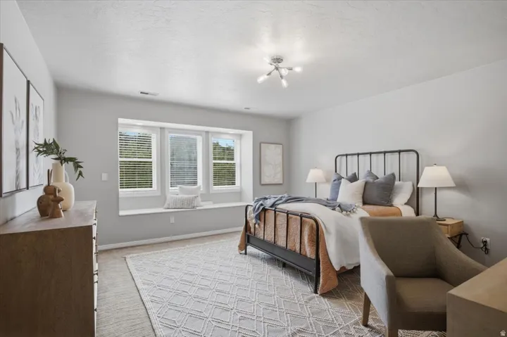 Recessed window seat with three windows, modern ceiling light fixture, and light gray wall paint