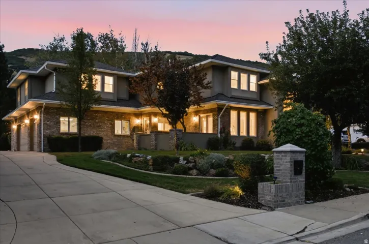 Stucco and brick exterior with a multi-level roofline