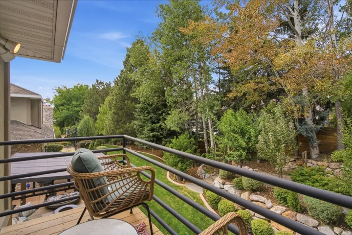 Expansive outdoor deck with wood-finish flooring and black metal railing