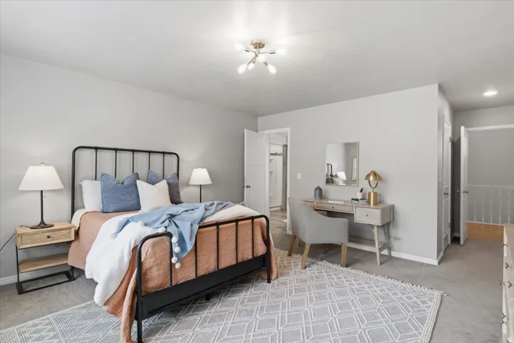 Recessed lighting, ceiling-mounted light fixture, carpeted flooring, and a white interior door
