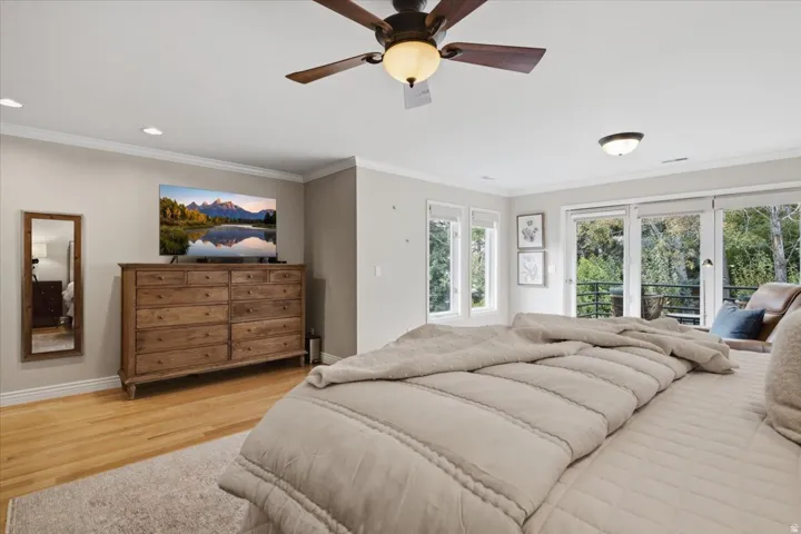 Wood-finish flooring, recessed lighting, and a ceiling fan with integrated light