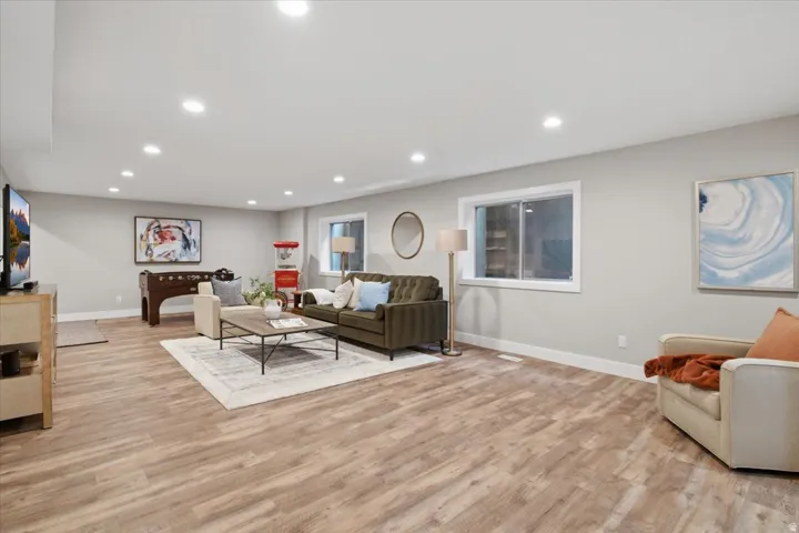 Spacious room with wood-finish flooring, recessed lighting, and light gray walls