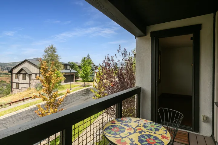 Outdoor balcony with wood-finish decking and metal railing