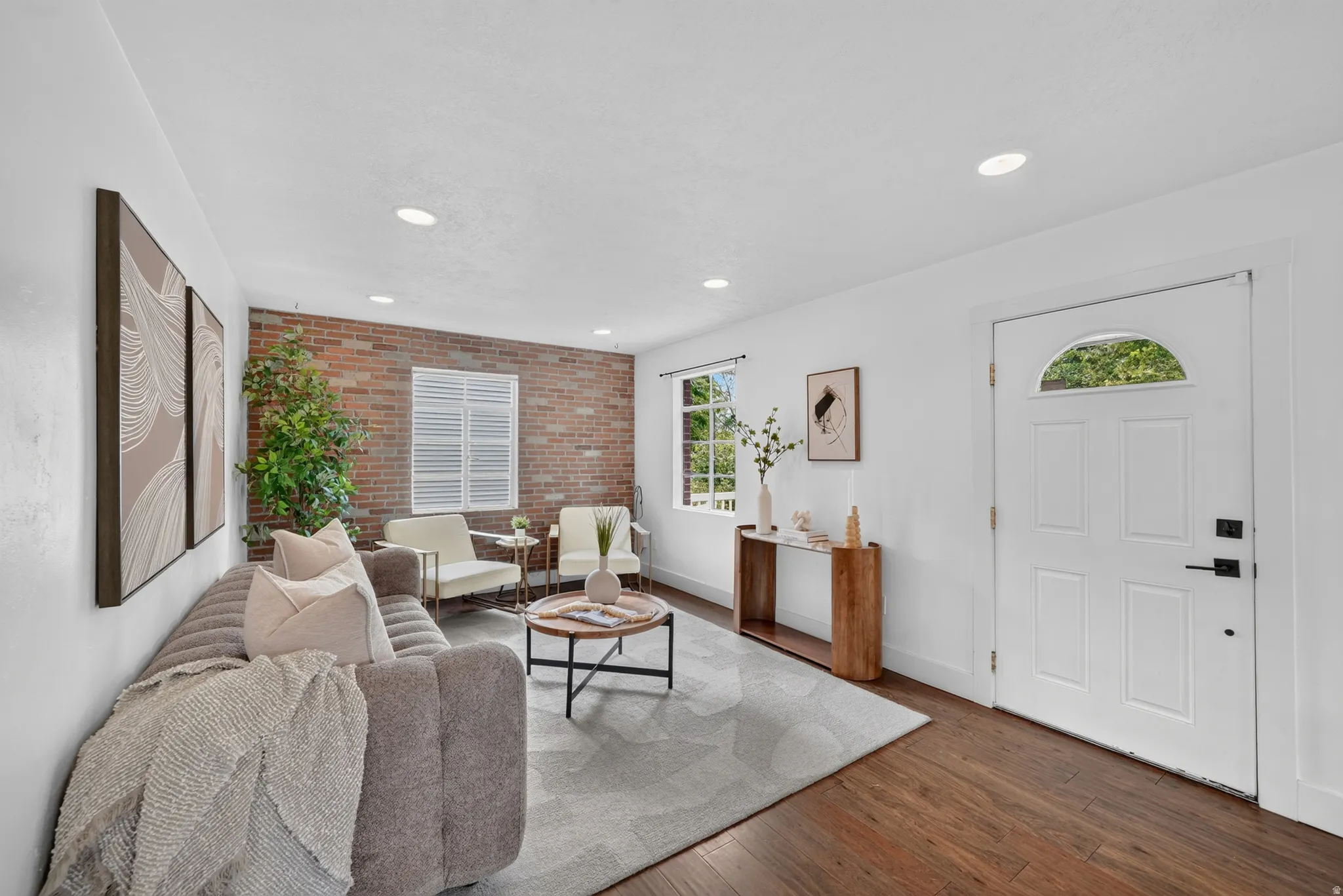 Welcoming foyer with recessed ceiling lighting and a white six-panel entry door featuring a transom window