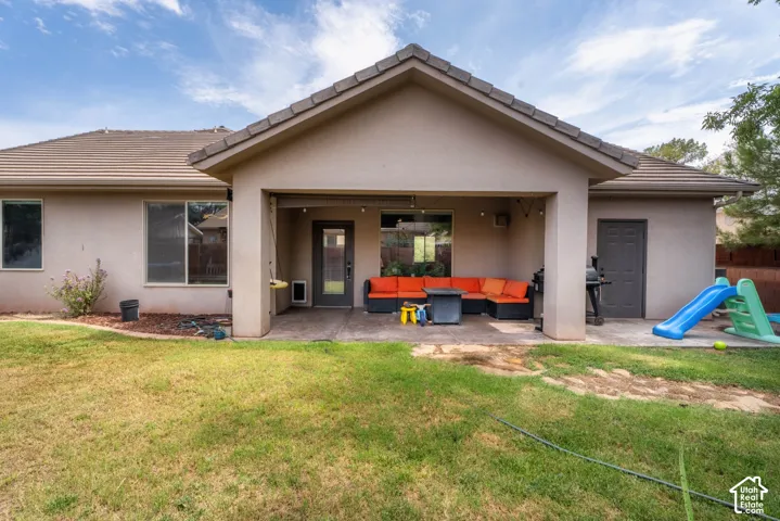 Covered patio area with concrete surfacing, exterior door access, and a stucco finish