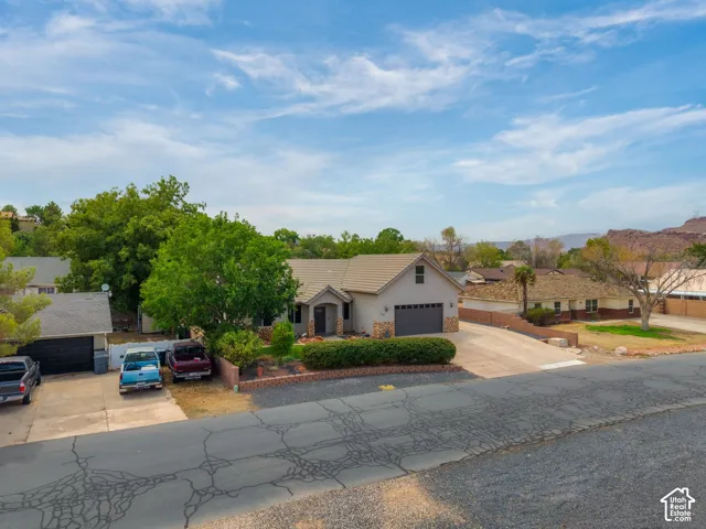 Charming single-story residence with a neutral stucco exterior and attached two-car garage