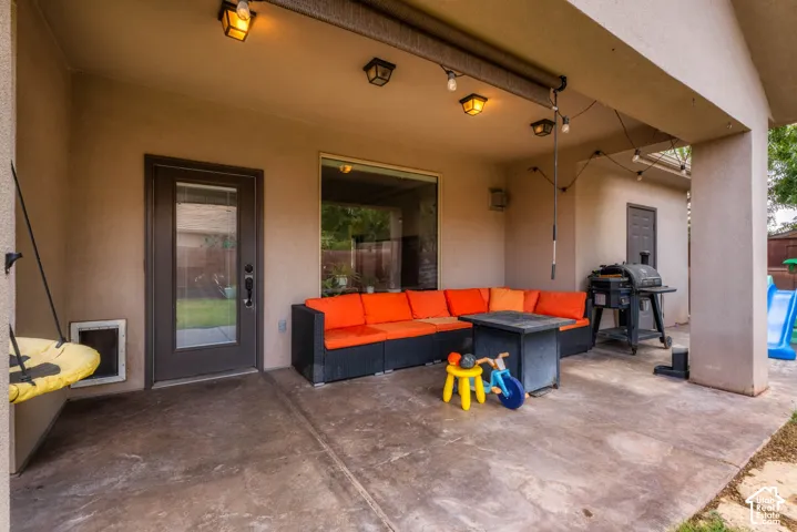 Covered patio featuring concrete flooring, recessed and track lighting, and direct access to the home via glass sliding door