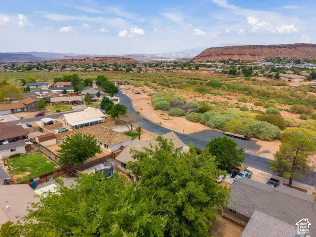 Scenic riverside property featuring mature shade trees, expansive grounds with manicured landscaping, and multiple outbuildings
