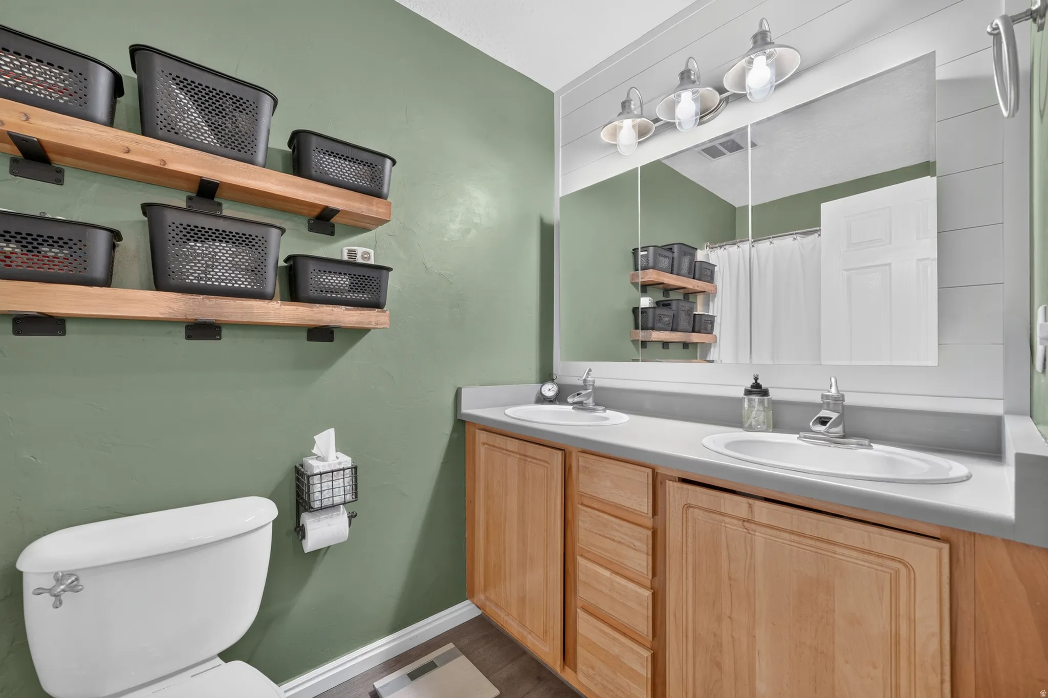 Primary Bath with double sink vanity and shower/tub combination.