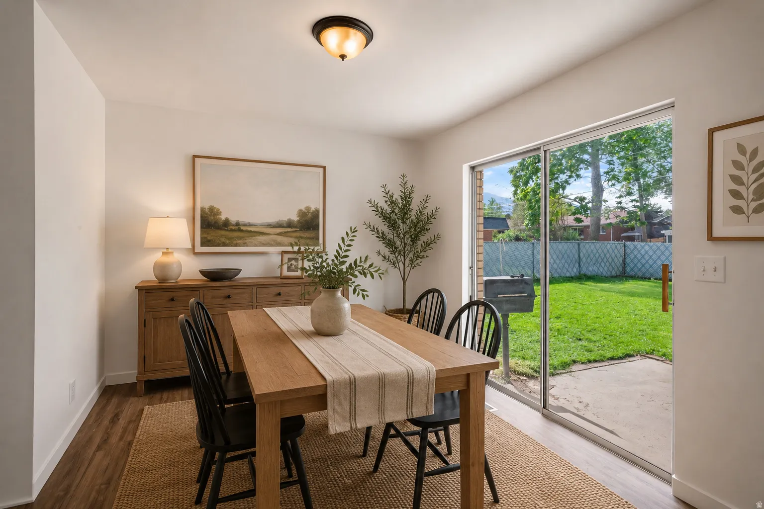 Wood-finish flooring throughout, white walls, and a recessed ceiling light