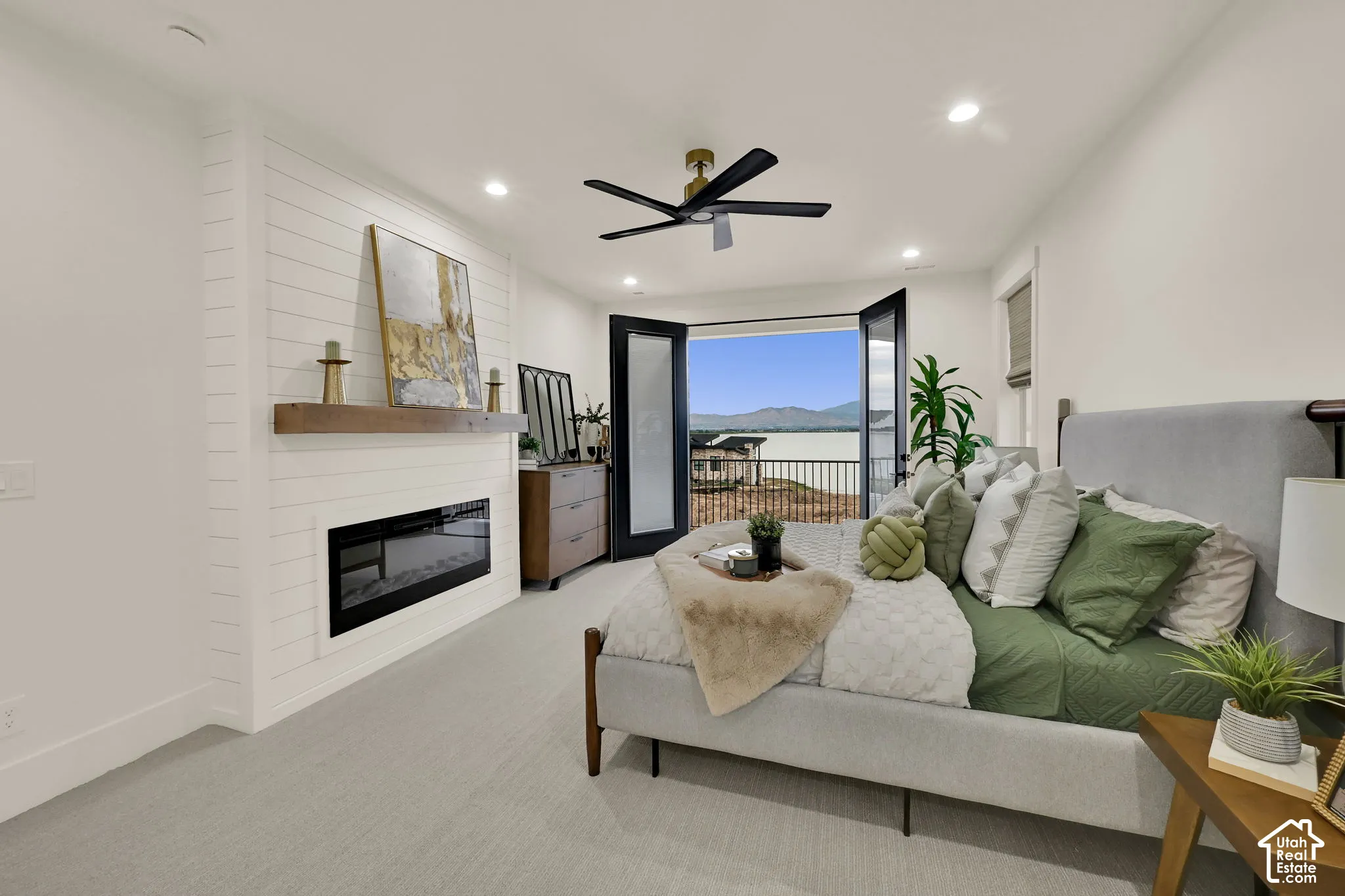 Shiplap accent wall featuring an electric fireplace with a wood mantle, recessed lighting, and a ceiling fan
