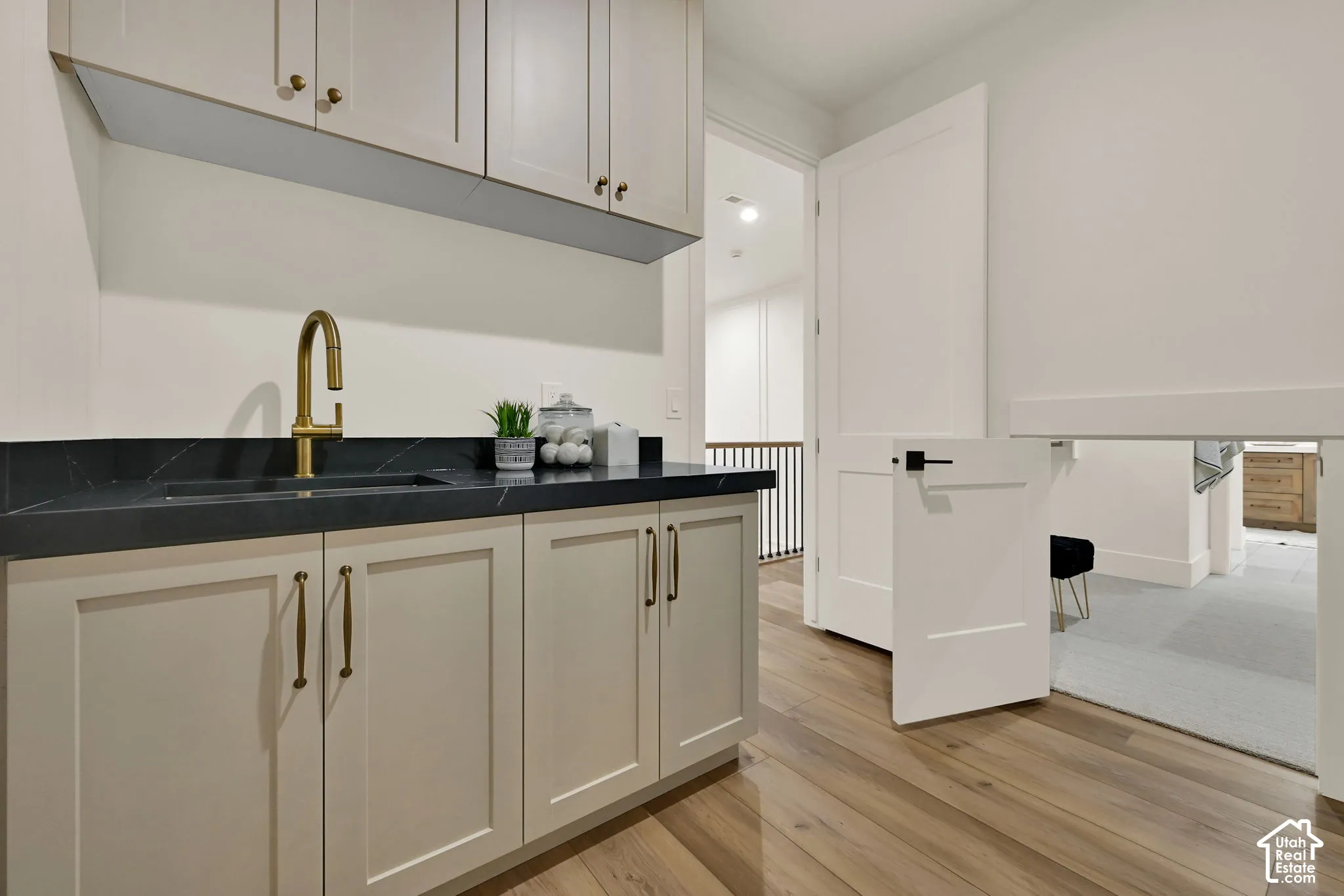 Integrated utility sink with a gold-finish gooseneck faucet