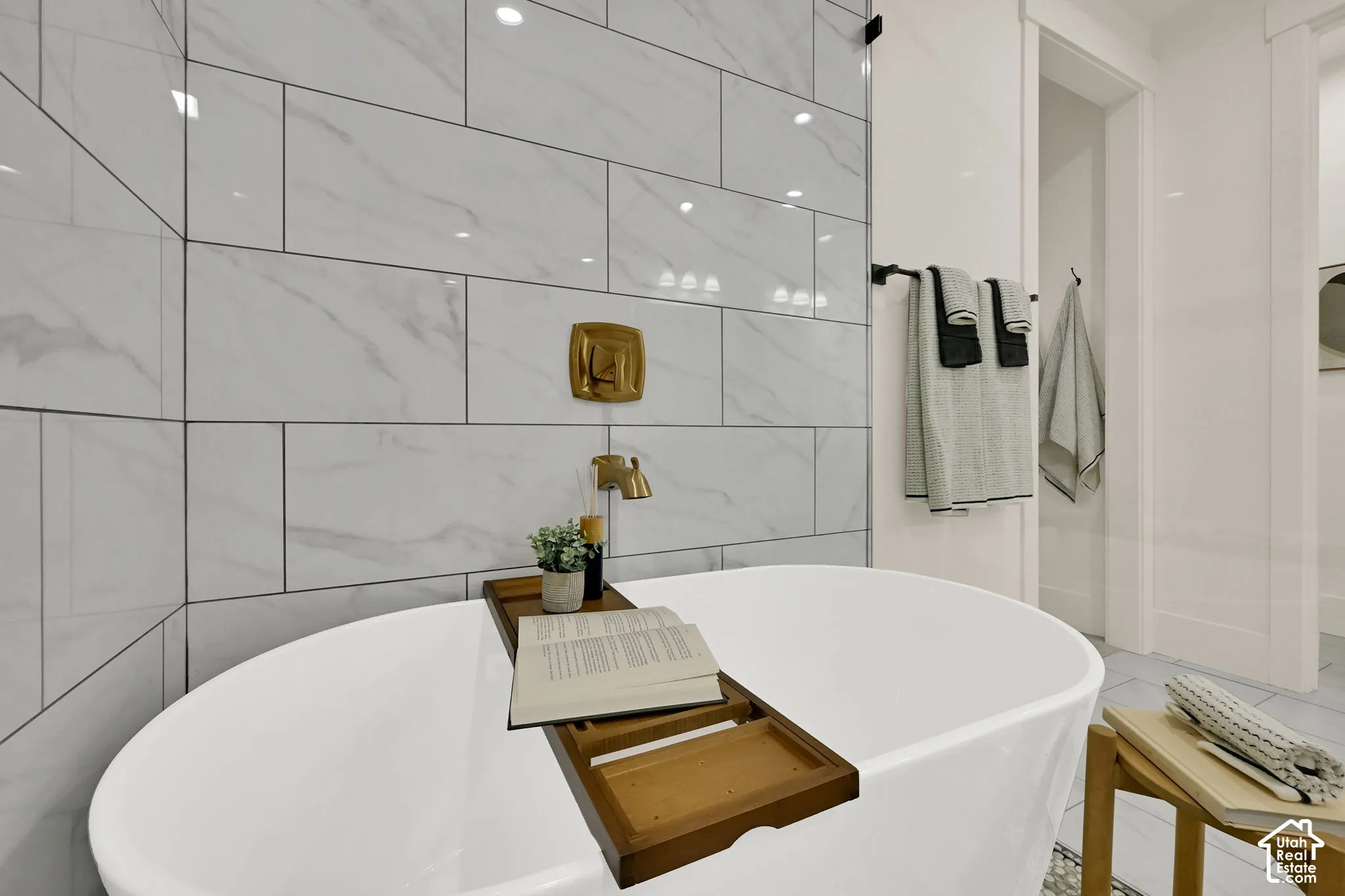 Freestanding soaking tub with gold-toned fixtures