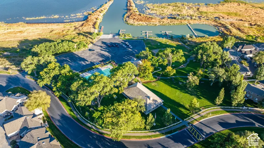 Community amenities including a swimming pool, boat docks, and green spaces, surrounded by residential properties and natural waterways