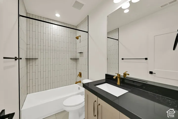 Bathroom featuring a full-sized tub, subway tile shower surround, and built-in shelving