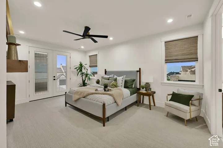 Recessed lighting, ceiling fan, white trim, dual French doors with a balcony, and window with woven shade