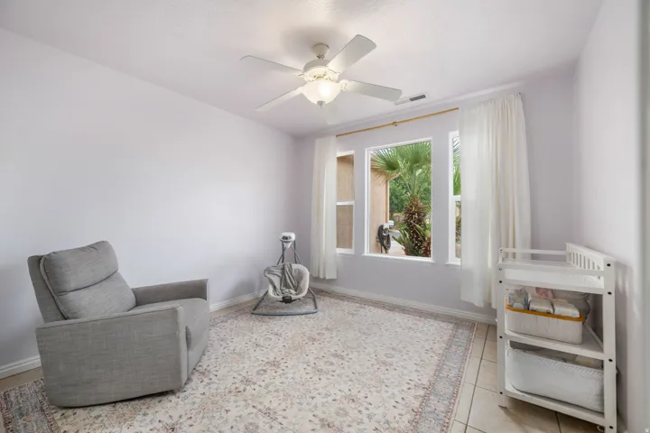 Recessed lighting and ceiling fan overhead, with large windows providing natural light