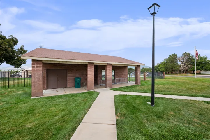 Brick municipal building featuring a clean, linear design with a covered entrance portico, multiple access points, and substantial lawn frontage