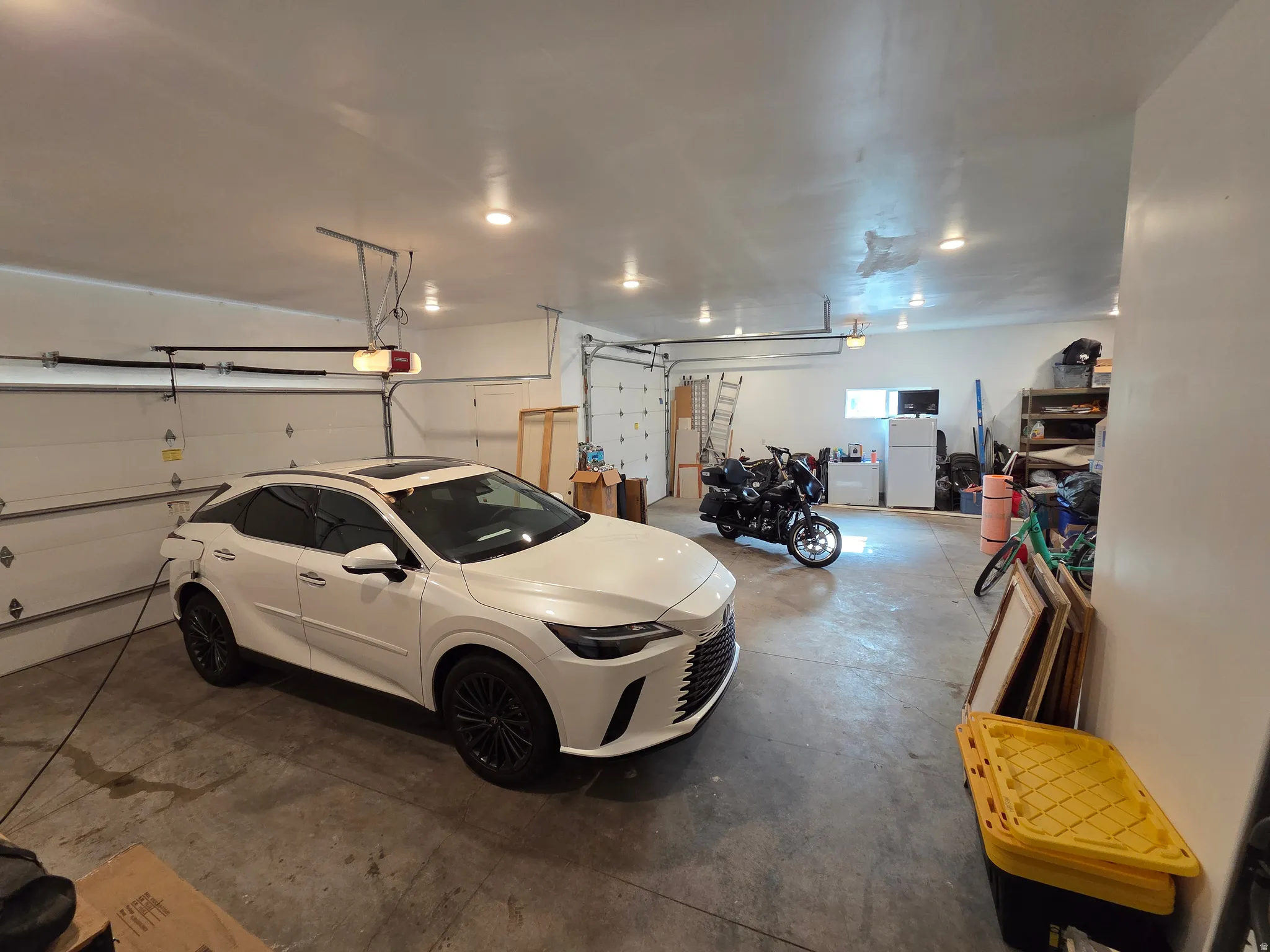 Spacious garage featuring polished concrete flooring, recessed lighting throughout, and ample storage capacity
