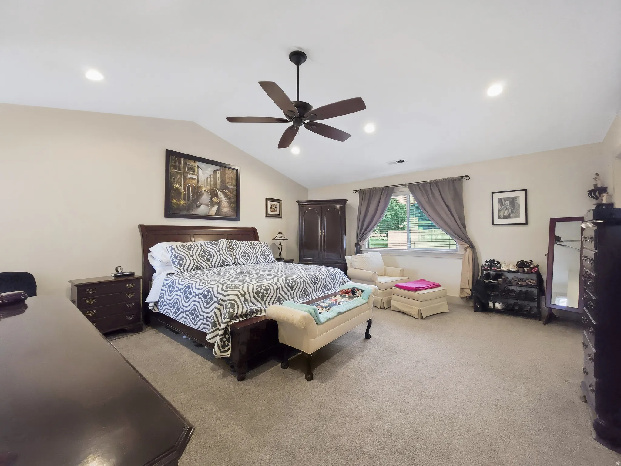 Vaulted ceiling with recessed lighting and ceiling fan