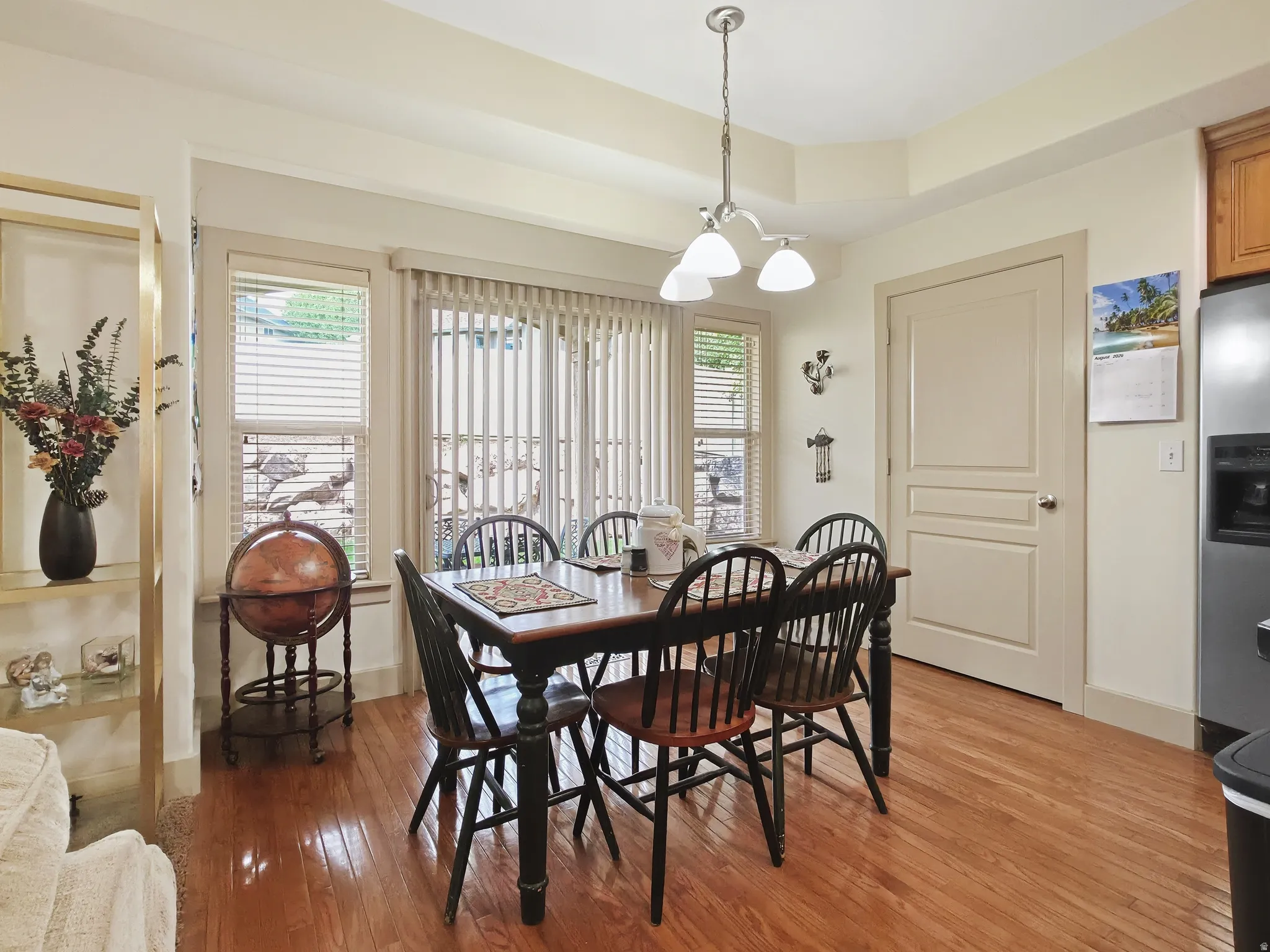 Hardwood flooring, tray ceiling, recessed lighting, white paneled door